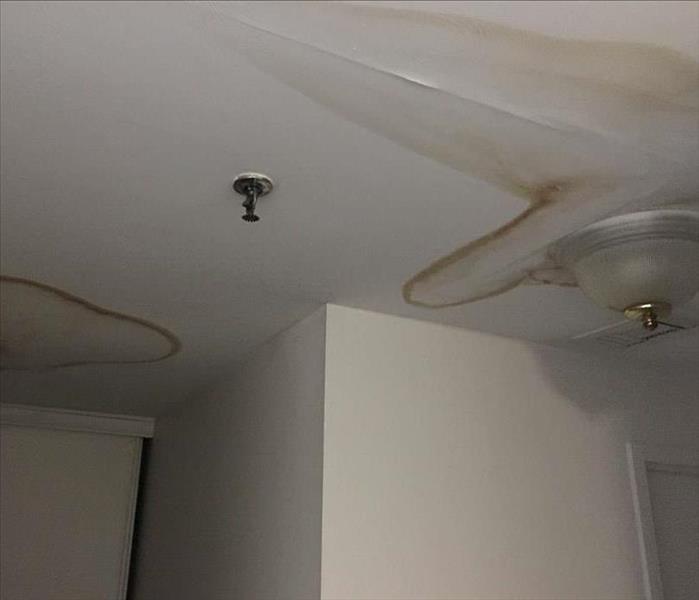 brown water stains on ceiling of home from a storm in New Jersey