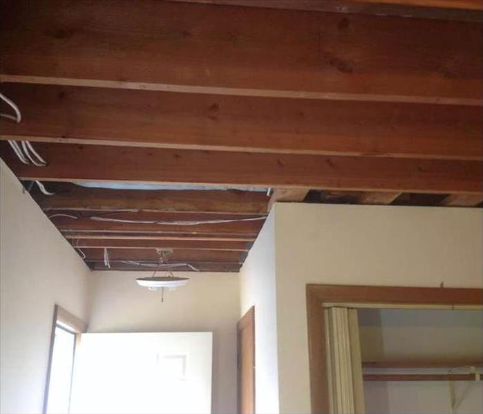 ceiling drywall was removed to properly dry the floor above to prevent mold growth and structural decay