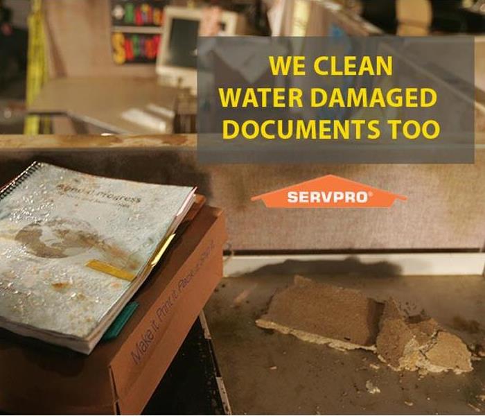 water damaged documents on box on desk, in office cube, wet tile, SERVPRO logo words we clean water damaged documents too