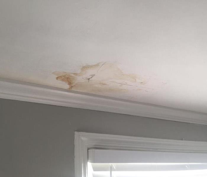 discoloration on a white ceiling from water damage