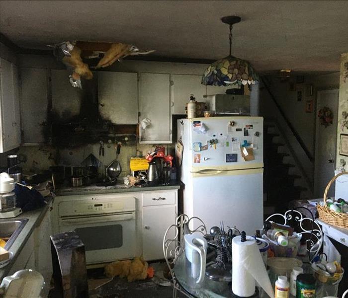 photo of kitchen after a fire, black smoke and soot everywhere