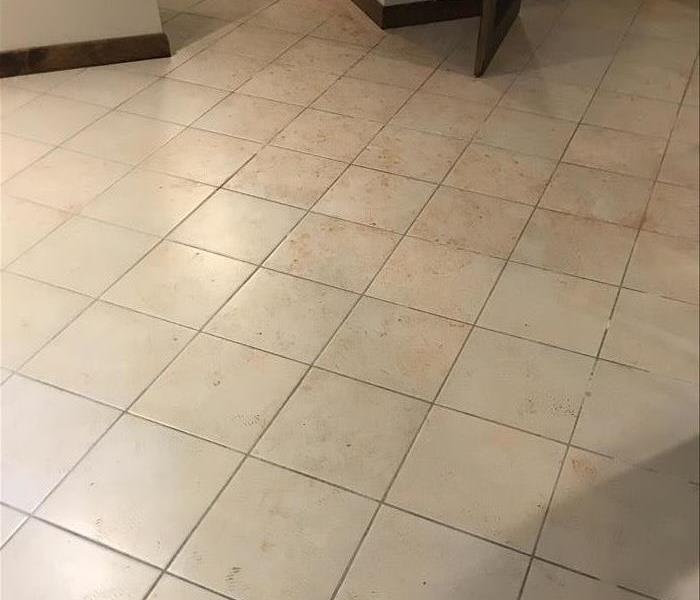 dirt marks left on tile floor after storm damage