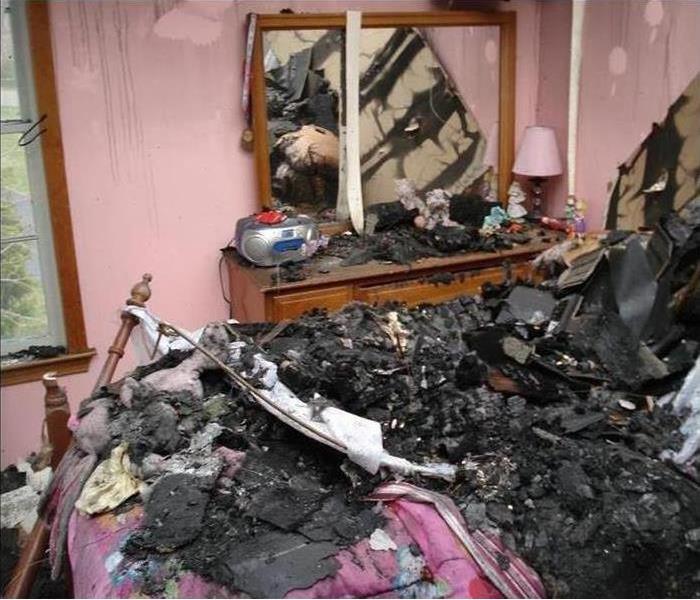 fire damage and debris in a bedroom