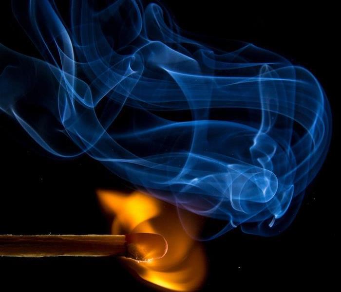 match ignites with smoke and fire on a black background